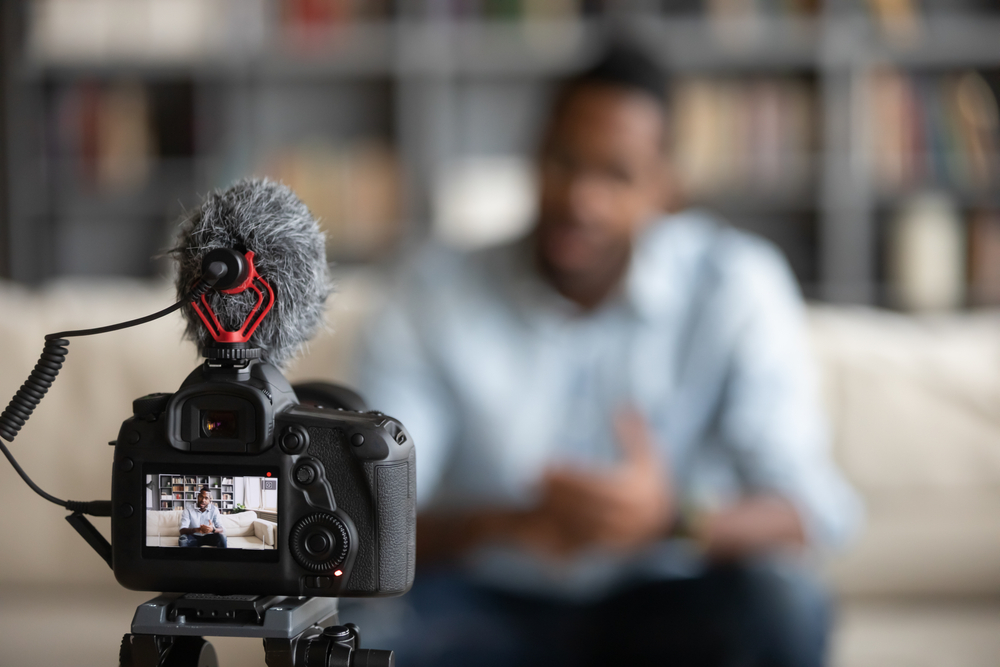 Close,Up,Focus,Of,Modern,Professional,Camera,Shooting,African,American